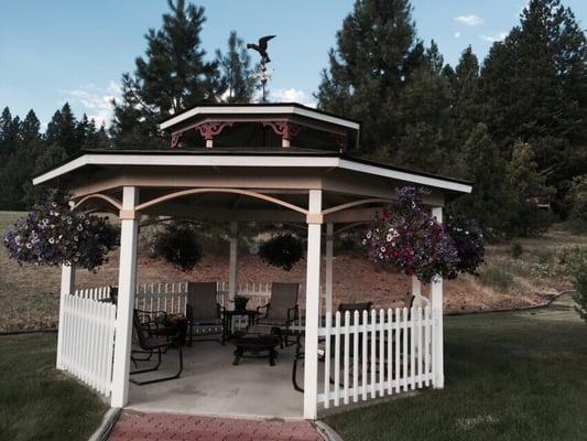 Outstanding gazebo on property with fire pit for night ambiance.