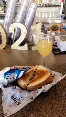 Jerk Chick Club with chips and a mimosa