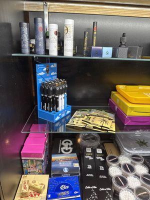 Display of premium accessories including vape cartridges, rolling papers, and storage solutions, perfect for enhancing your weed experience.