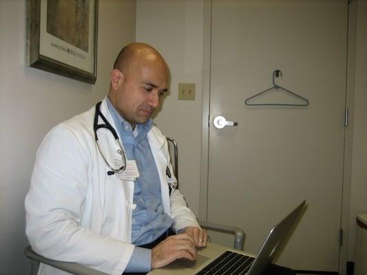 Dr. Savant and the Apple laptop he uses during your appointment.