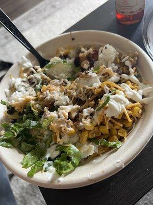 Bulgogi bowl with chicken, corn, lettuce, white rice and white sauce.