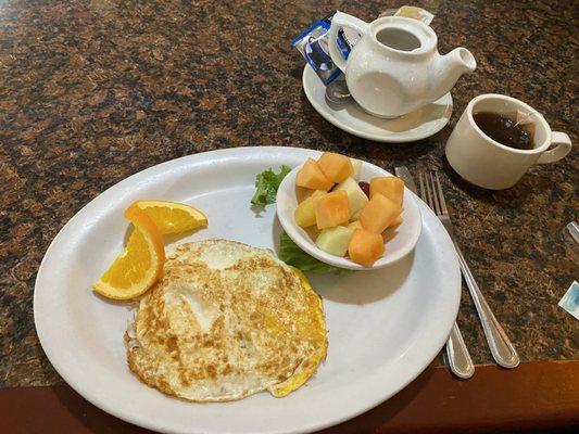 Egg (over hard), small fruit bowl, and English Breakfast Tea