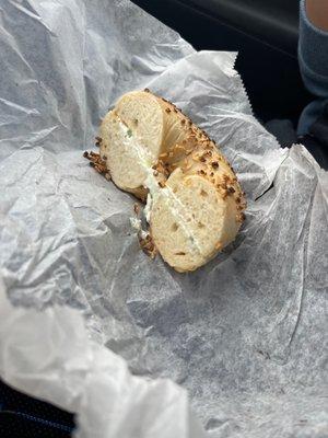 1/2 of garlic bagel with scallion cream cheese (other half was being eaten)