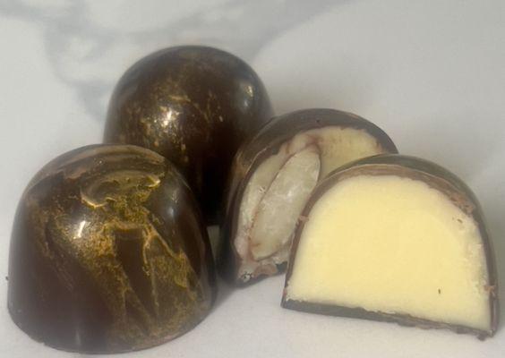 Decadent caramelized white chocolate ganache, enveloped in rich black chocolate, with a crunchy almond twist.