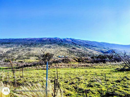 Majestic Mauna Kea in the background, Gilbert Kahele Recreation Area in the distance. POV from Saddle Road.