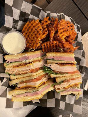 Clubhouse sandwich with sweet potato fries.