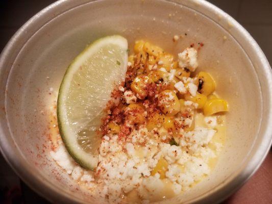 Esquites elotes w/onion, serrano, chile guajillo aioli and queso cotija. Delicious.