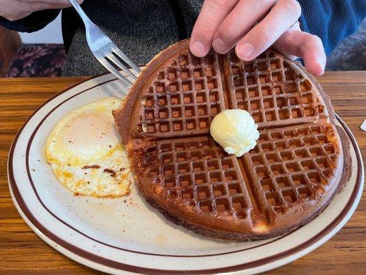 Burnt plain waffle and over medium egg