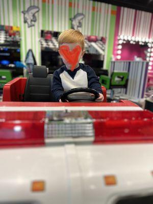 Happy kid to get his haircut in a fire truck.