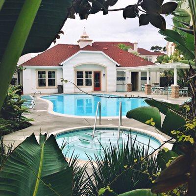 One of our pools & spas that make us smile! Aren't those red roofs and turquoise chairs awesome?