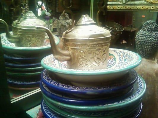 stunning  worked metal pots and decorated plates and platters upstairs in this store