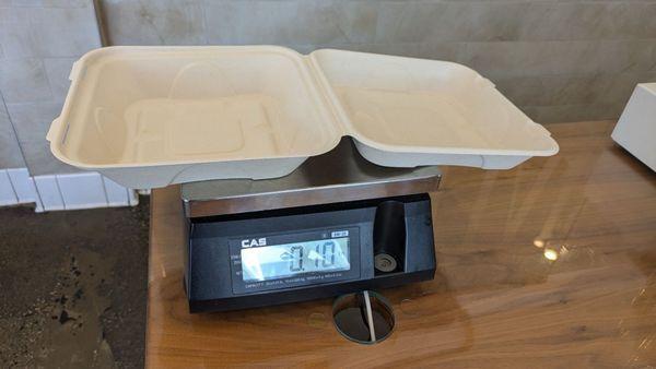 The scale at the cashier, with an empty container.