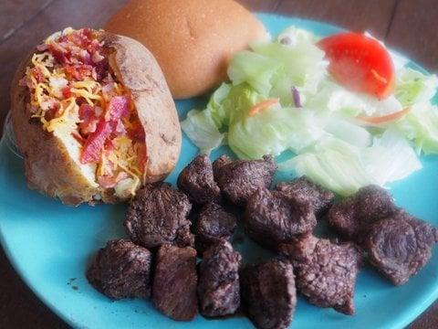 A customer favorite-steak tips and loaded baked potato