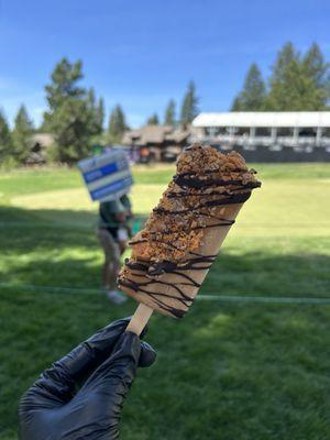 Espresso pop dipped with cookie butter shell, butterfingers topping & dark chocolate drizzle