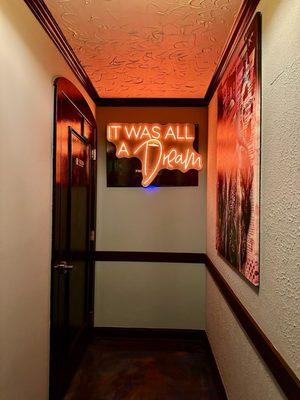 Bathroom-adjacent neon sign