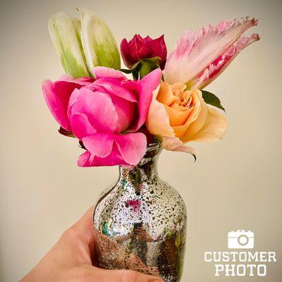 Assortment of tulips blooming in a vase.