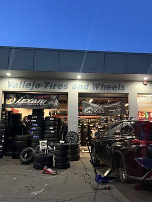 Disorganized messy shop with owner just casually standing in there