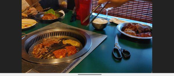 Using the grill at the table. The scissors work great and help alot with cooking meat faster.