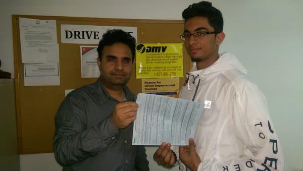 Giving certificate to teen student from the school of driving