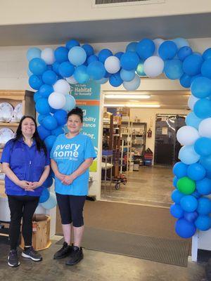 Two of our ReStore cashiers pose in front of balloons to celebrate our expansion.