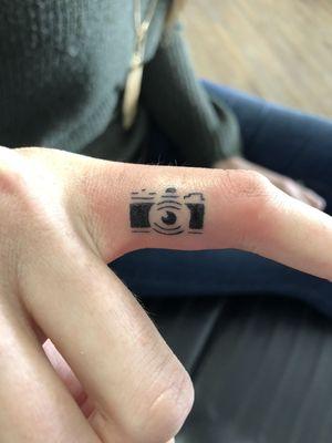 Crisp micro tattoo on the shutter finger