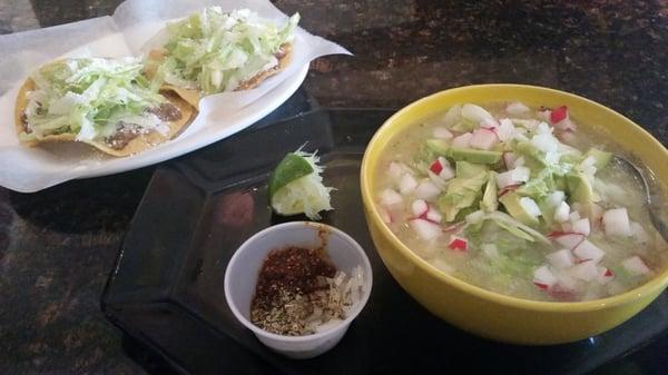 This is Pozole, mexican soup with a side of 2 tostadas