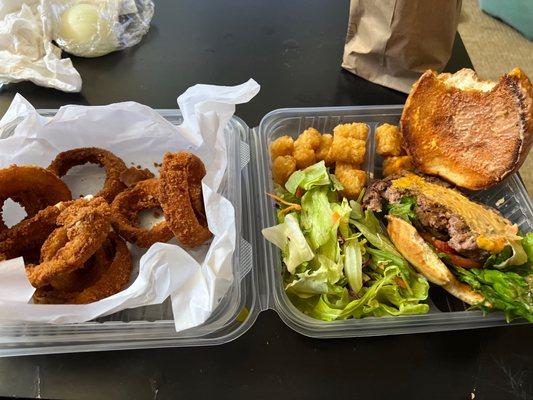 Onion Rings on the left and the burger I didn't order! Where's my Spicy Avocado Cheese Burger I paid for?!