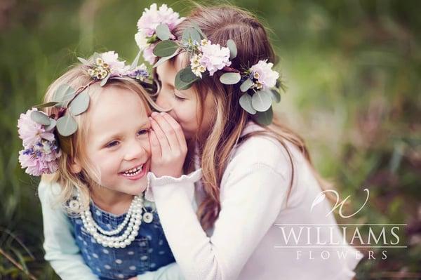 Daughters playing with their floral crowns.