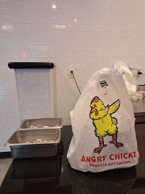 To Go bag has a dabbing chicken logo