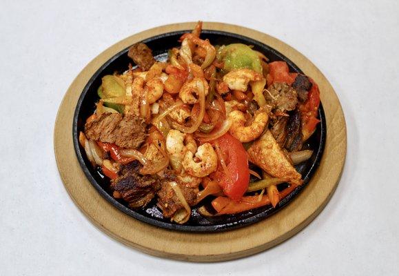 Fajita Texana- Chicken, Shrimp, Steak served w/ rice, beans, & corn tortillas