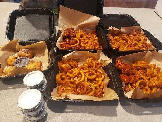 Boneless chicken wings with curly fries and deep fried oreos