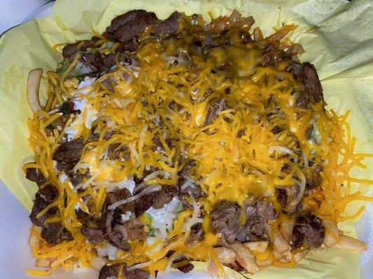 Super Fries (carne asada fries) from Los Fredos on Jackson/Magnolia. Hits the spot at 1am with an ice cold Horchata to wash it down....