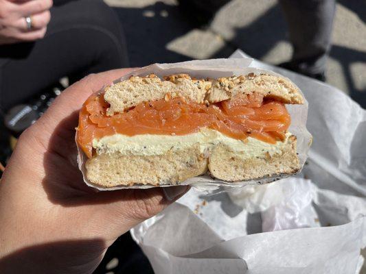 Wheat everything bagel with avocado cream cheese and lox.