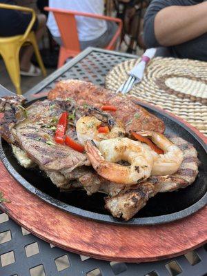 Mixed grill plate with steak, chicken, sausage, shrimp and pork. This comes with rice, French fries and salad