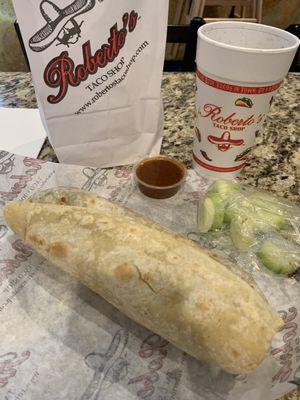 Carne Asada Burrito and cucumber slices with a Pepsi Zero.