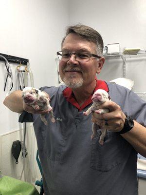 Dr Andy showing off two of the five babies he delivered.