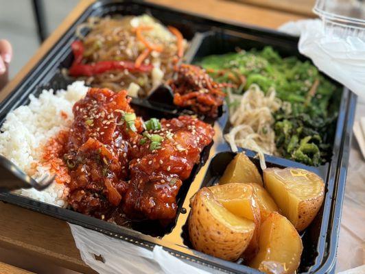 Sweet spicy chicken, braised potatoes, japchae and seaweed salad.