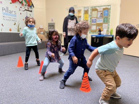 Toddlers having fun jumping an obstacle race!