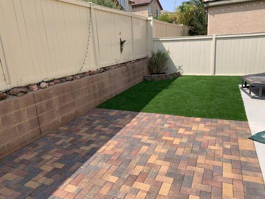 Pavers, artificial grass, retaining wall & Texas ranger plant installed