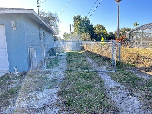 The tenants removed my gate and added their own so they could drive into the backyard and stack all their materials.  truck tracks!