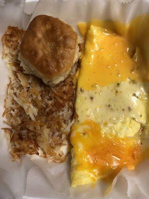 Cheese omelette with hash browns and biscuit.