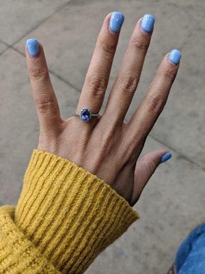 A beautiful tanzanite with a halo of diamonds for a unique engagment ring!