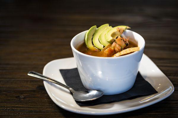 Homemade chicken tortilla soup with fresh avocado