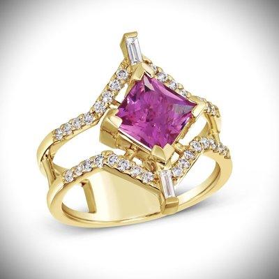 Vivid pink tourmaline set in yellow gold with diamond accents.