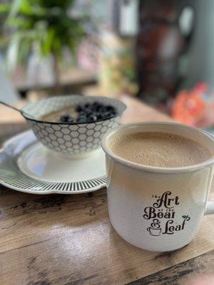 Oatmeal, blueberries, and a latte.