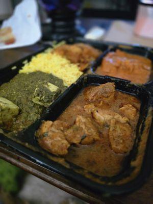 Combo plate with spicy fish and chicken curry, palak paneer and mushroom veggies sides