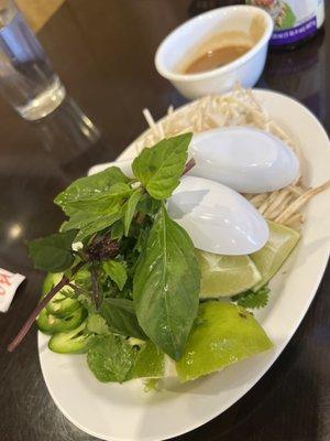 Sides of Cilantro, Lime, Sprouts, Basil I believe, and Jalepeño. Complementary with the Phó