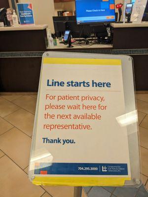 This sign will be available to let patients know where the line starts for check-in