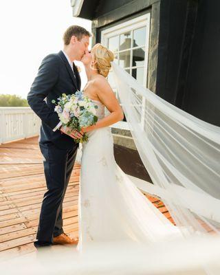 Just Married and sharing a kiss at the top of the Windmill.