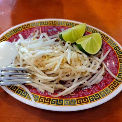 Fresh bean sprouts with lime wedges